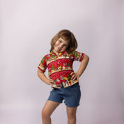 Happy Santa red kids shirt with festive print, paired with classic blue denim shorts. Tropical holiday style. | Tropicool Clothing