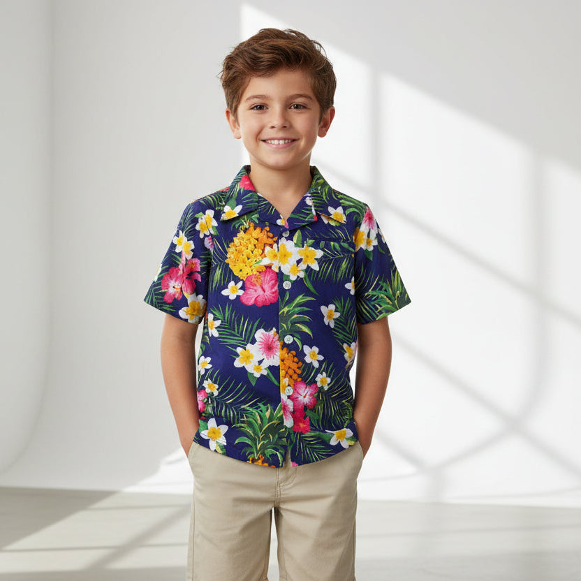 A navy blue children's shirt with a tropical floral print, including images of flowers such as hibiscus.