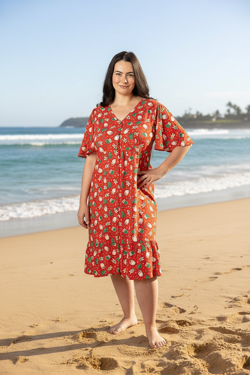 Close-up of the Tropicool Alice Gingerbread Jest adult dress, showing the festive gingerbread print as the model smiles with a hand on her hip