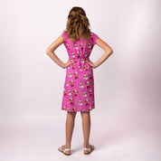 Back view of the Tropicool Holly Santa Polka Pink Child Dress showing the pink Santa print and relaxed Holiday fit for kids