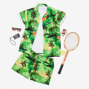 Tropical green short-sleeve shirt and shorts set with sunset-inspired design; festive, vacation-ready attire. | Tropicool Clothing