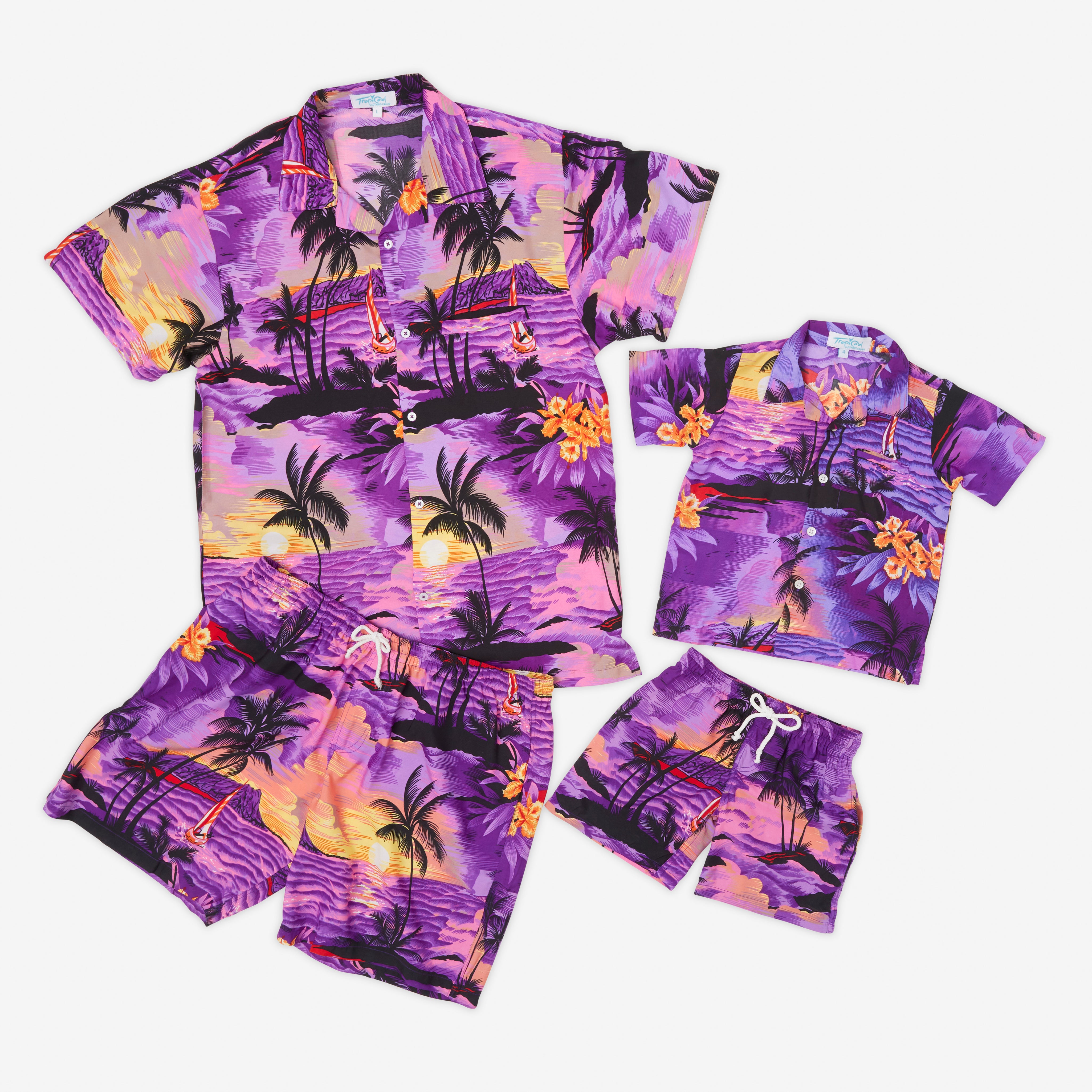 The Sunset Purple Kids Hawaiian Shirt and Shorts Set features vibrant tropical prints in purple, pink, and orange with palm trees—perfect for summer and pictured laid flat on a white background.